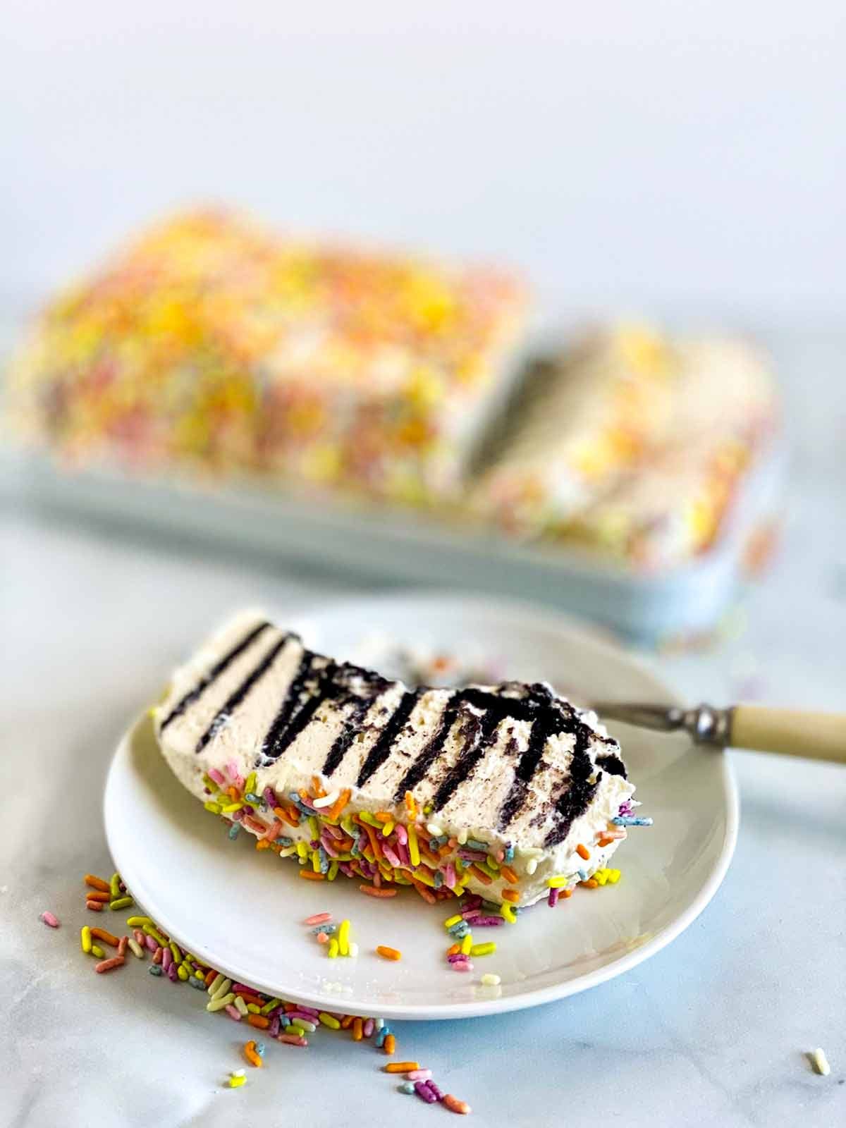 A sliced chocolate wafer icebox cake showing layers of cookies and whipped cream.