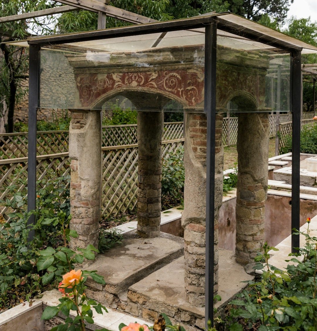 a stone structure with a painting on the side of it a stone structure with a painting on the side of it
