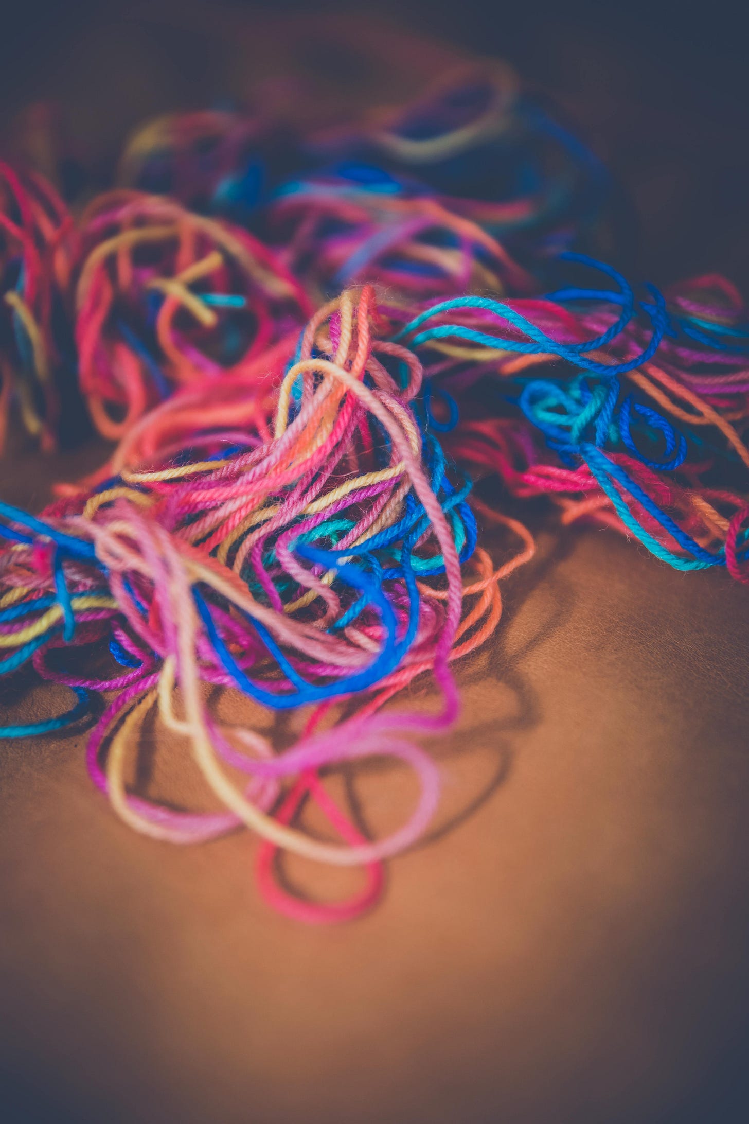 A pile of colorful threads

AI-generated content may be incorrect.