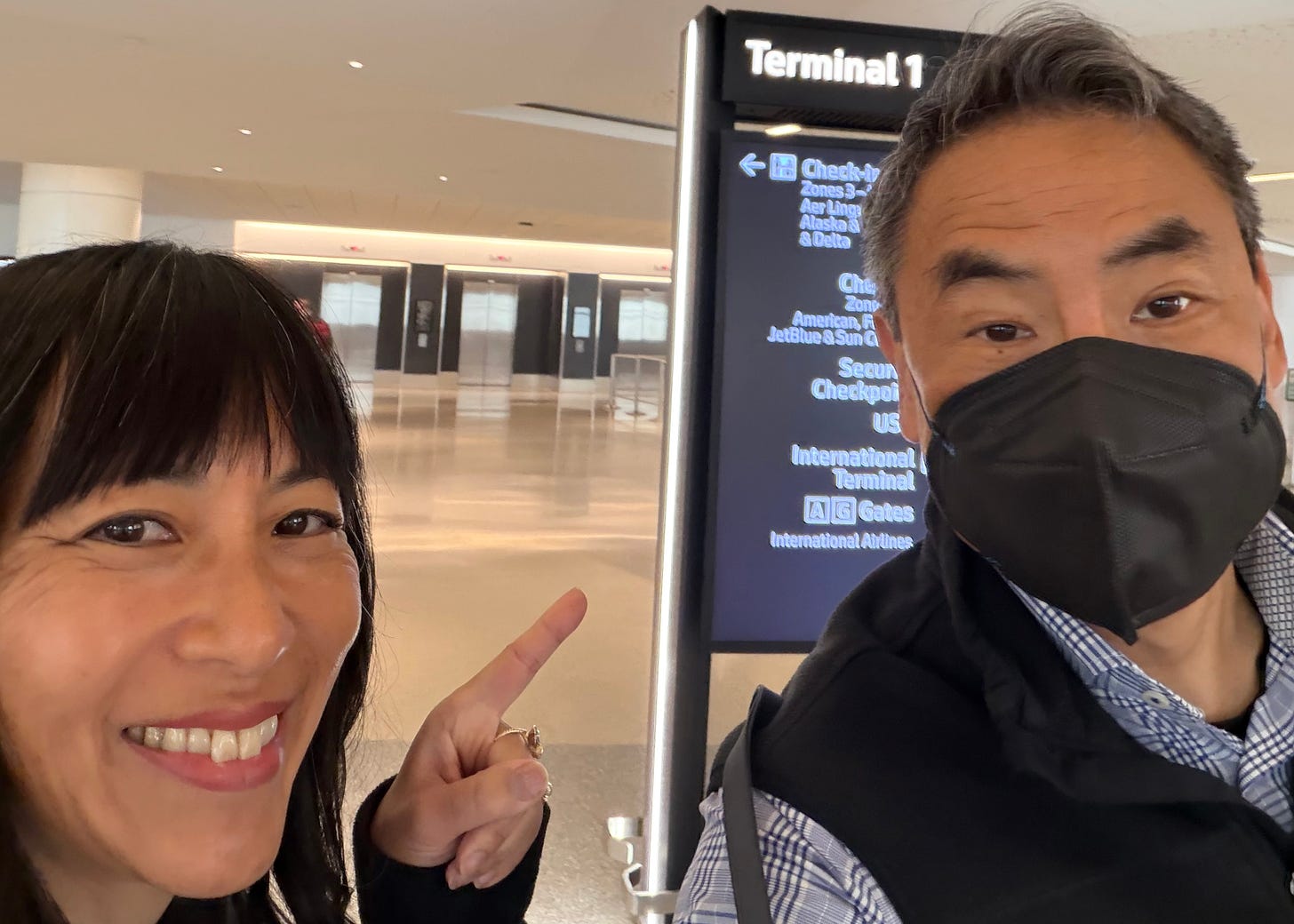 Marsha Pao and Stephen Pao (with a mask on)in Terminal 1 at SFO airport