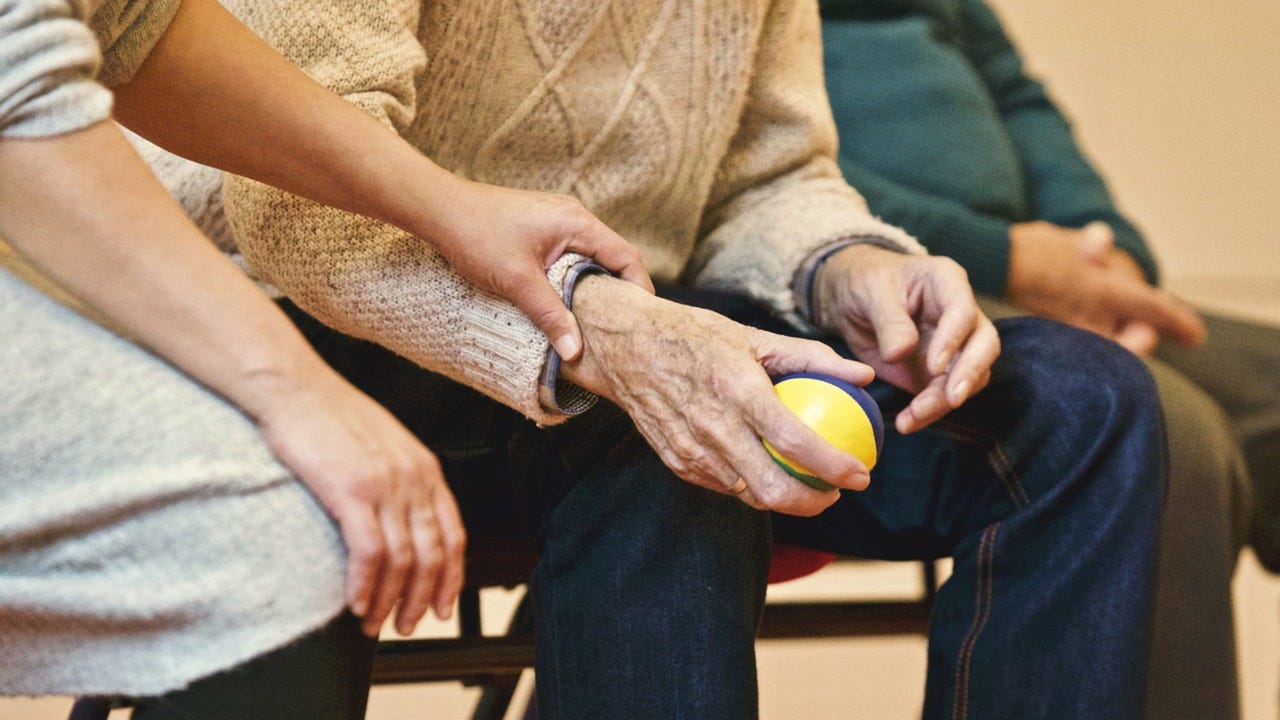Elderly couple holding hands