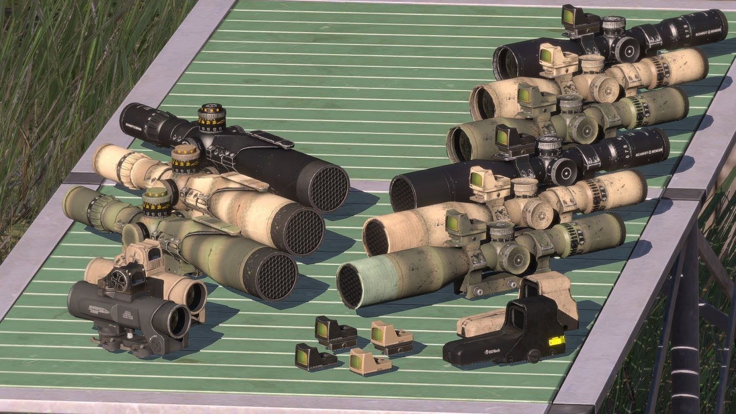 a collection of assorted optical sight attachments for military rifles