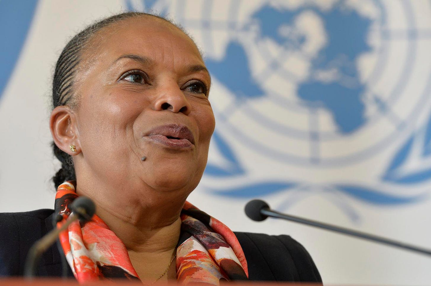 A photo of French politician Christiane Taubira in front of the UN logo A photo of French politician Christiane Taubira in front of the UN logo