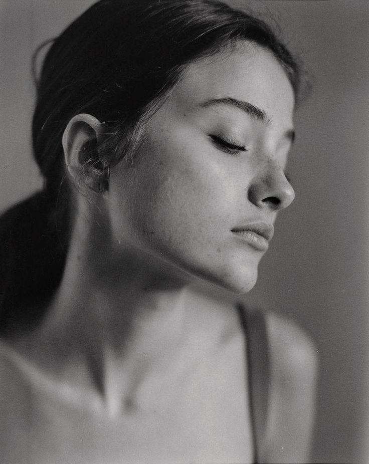 This may contain: a black and white photo of a woman with her eyes closed