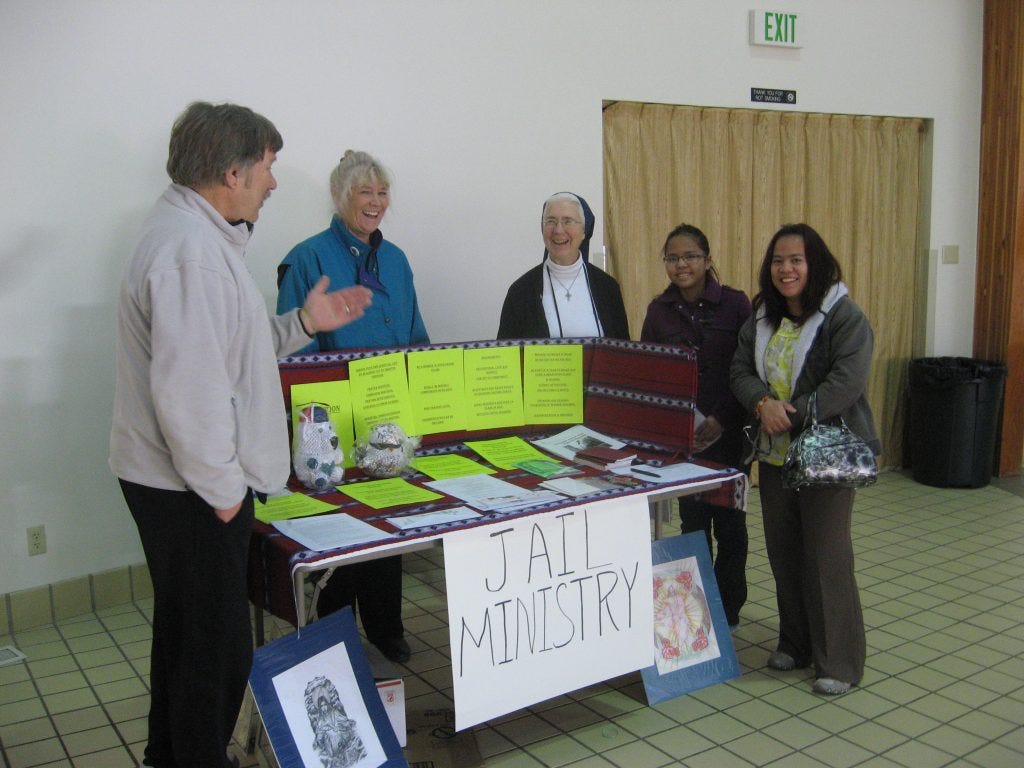 Sr. Racko, center, with volunteers at a recent ministry fair.