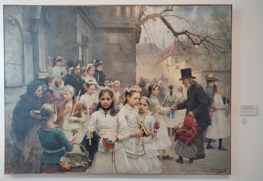A painting of young girls outside a church after their first communion. The scene is full of people, but attention is drawn to three girls in the foreground by the sharp, almost photo-realistic depiction of their features. The one in the front is the only character who seems to look directly at the viewer, holding attention