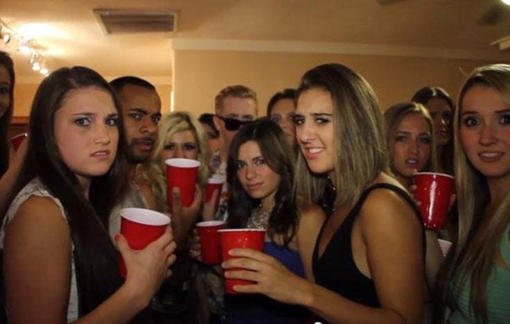 This may contain: a group of people holding red cups in front of each other with the caption that reads, that book you get when you need that smiling is better than