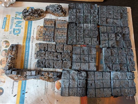 3 photos of dungeon tiles, walls, stairs, and miniatures. 1 showing all the pieces laid out, 1 showing a sample map, and 1 showing a dynamic combat on the tiles.