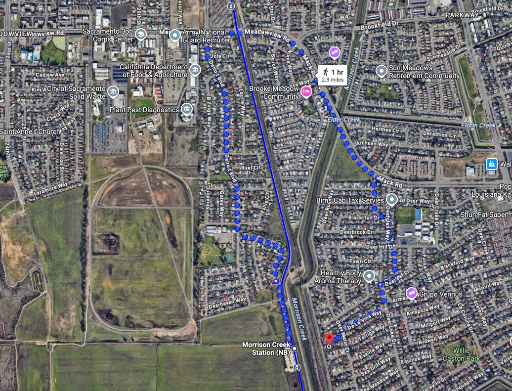 A Google Maps photo showing that it would take an hour or 2.8 miles walking to get from a single-family home to a light rail stop, as they're divided by a river. A Google Maps photo showing that it would take an hour or 2.8 miles walking to get from a single-family home to a light rail stop, as they're divided by a river.