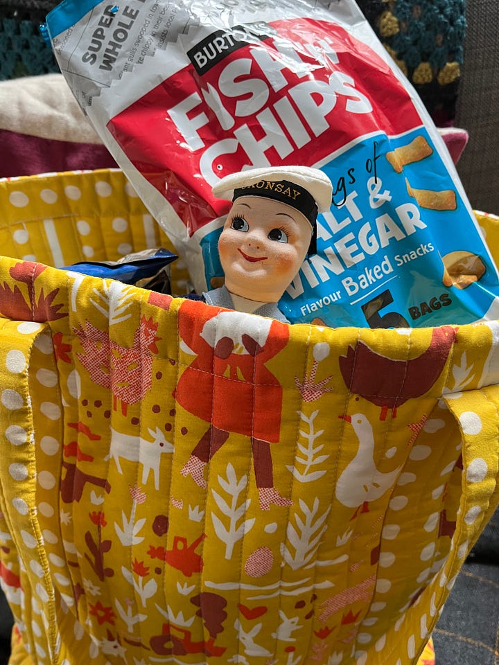 Yellow bag full of crisps, evil Easter bunny drawing by a child, tiny daffodils peeping through, upside down chick