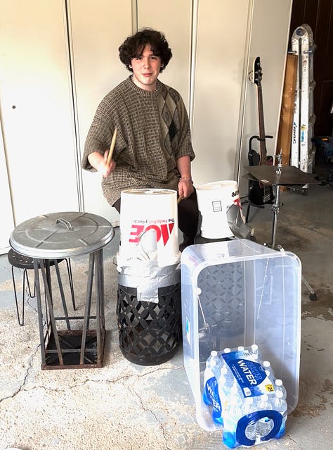 A guitar made out of a lunchbox and a broken guitar neck, a bass made out of a surplus military box, and a drum set made out of, basically, trash