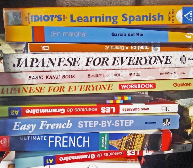 This may contain: there are many books stacked on top of each other