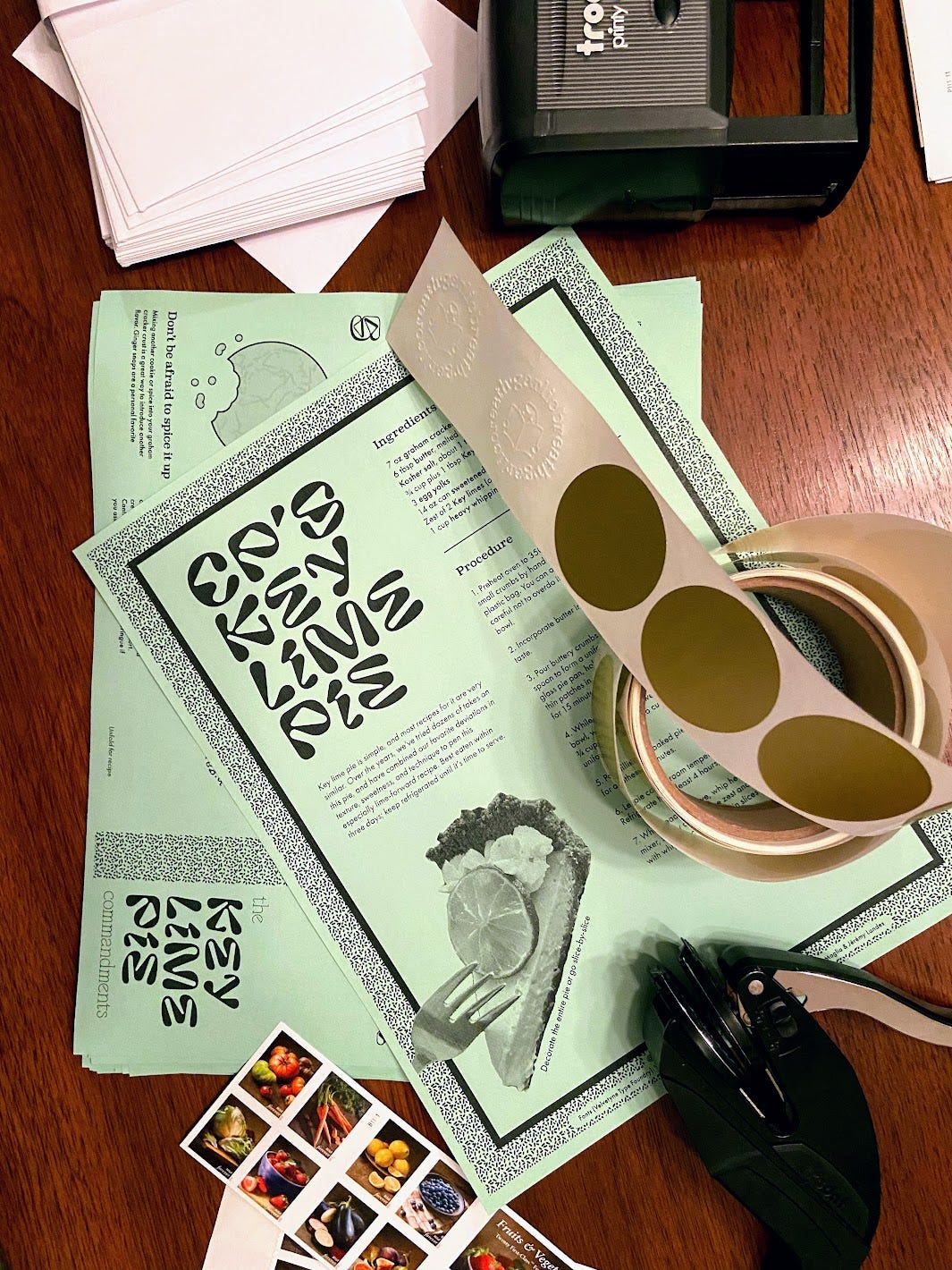The zine before being folding, exposing the recipe. With stickers, stamps and envelopes.