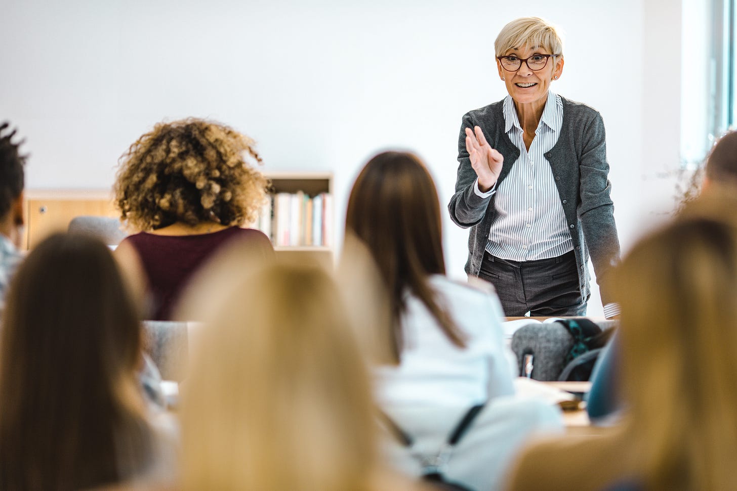 A professor leads a classroom discussion with students. A professor leads a classroom discussion with students.