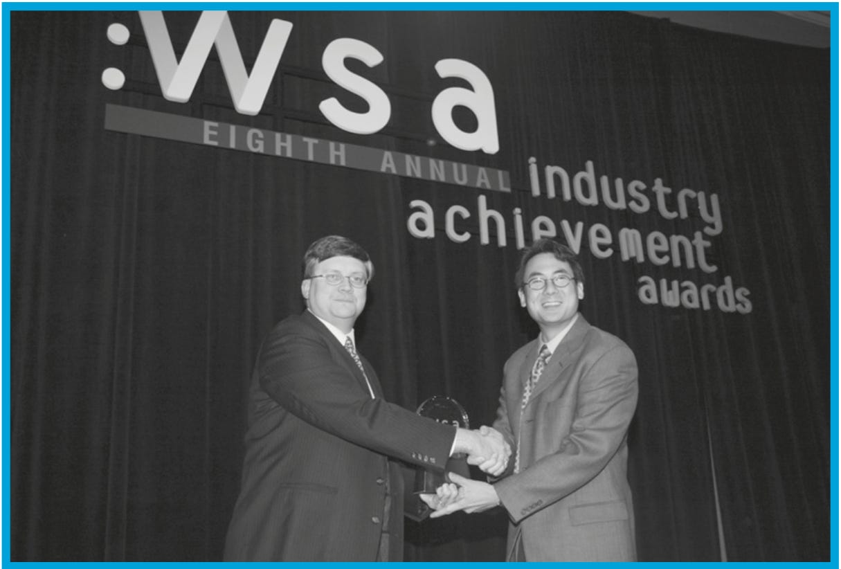 Awards ceremony with a presenter shaking hands with a recipient Awards ceremony with a presenter shaking hands with a recipient