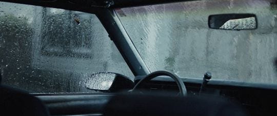 This may contain: the interior of a car is covered in rain