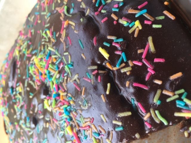 Close up of a chocolate cake with rainbow sprinkles Close up of a chocolate cake with rainbow sprinkles