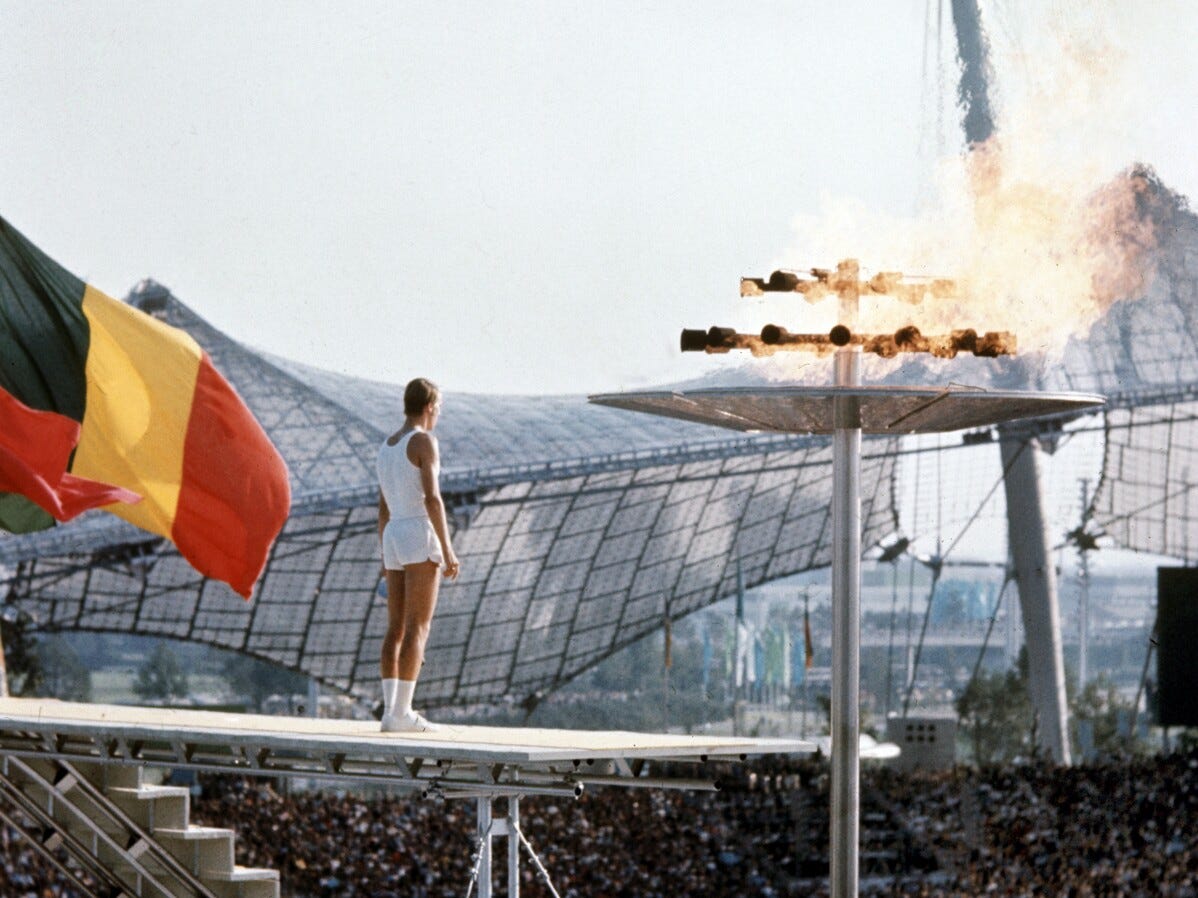 Junior athlete Guenther Zahn, 18, stands proudly near the Olympic flame he ignited above the stadium on August 26, 1972, during the dramatic opening ceremony of the Summer Olympic Games in Munich, Germany.