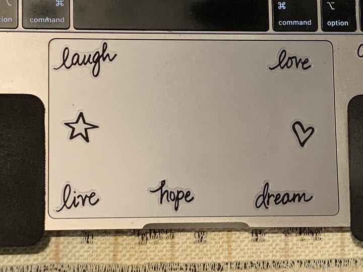 Laptop computer with inspirational stickers on it