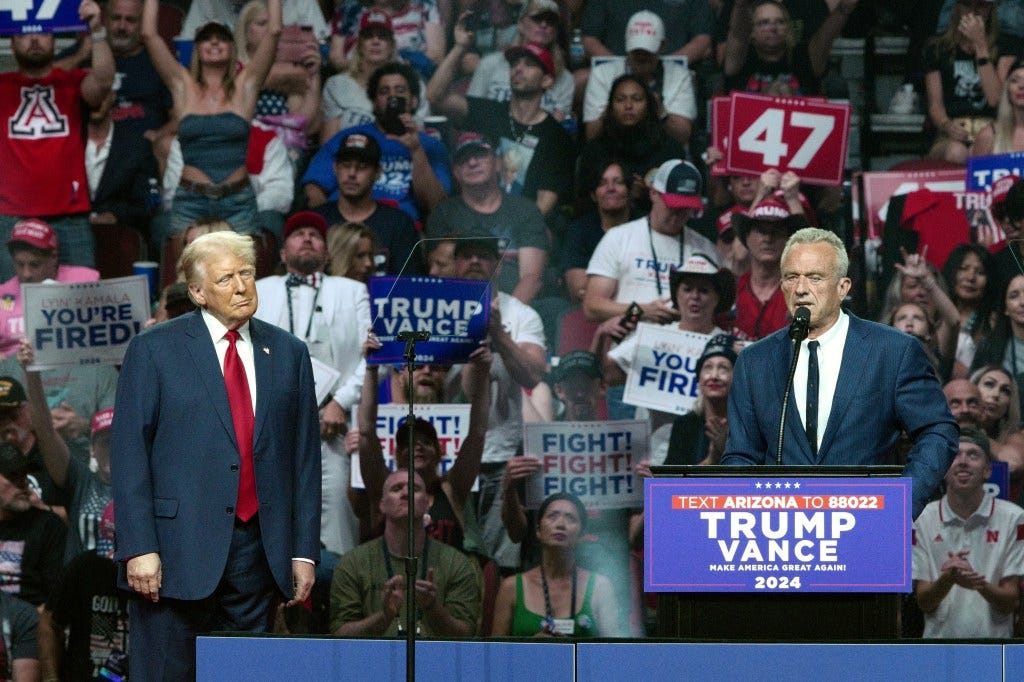 Former US President and Republican presidential candidate Donald Trump (L) listens to Independent presidential candidate Robert F. Kennedy Jr. (R) speak during a campaign rally at the Desert Diamond Arena in Glendale, Arizona, August 23, 2024 Former US President and Republican presidential candidate Donald Trump (L) listens to Independent presidential candidate Robert F. Kennedy Jr. (R) speak during a campaign rally at the Desert Diamond Arena in Glendale, Arizona, August 23, 2024