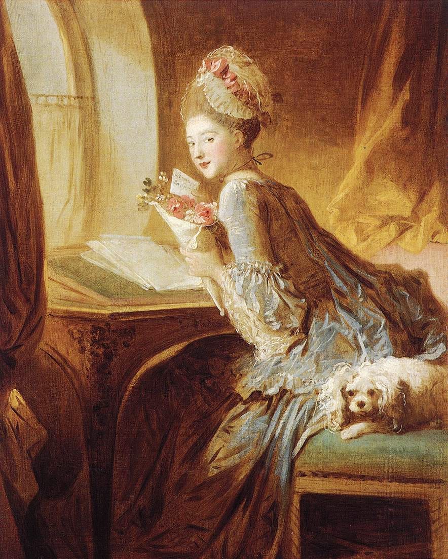 A young woman at a desk with a note and flowers A young woman at a desk with a note and flowers