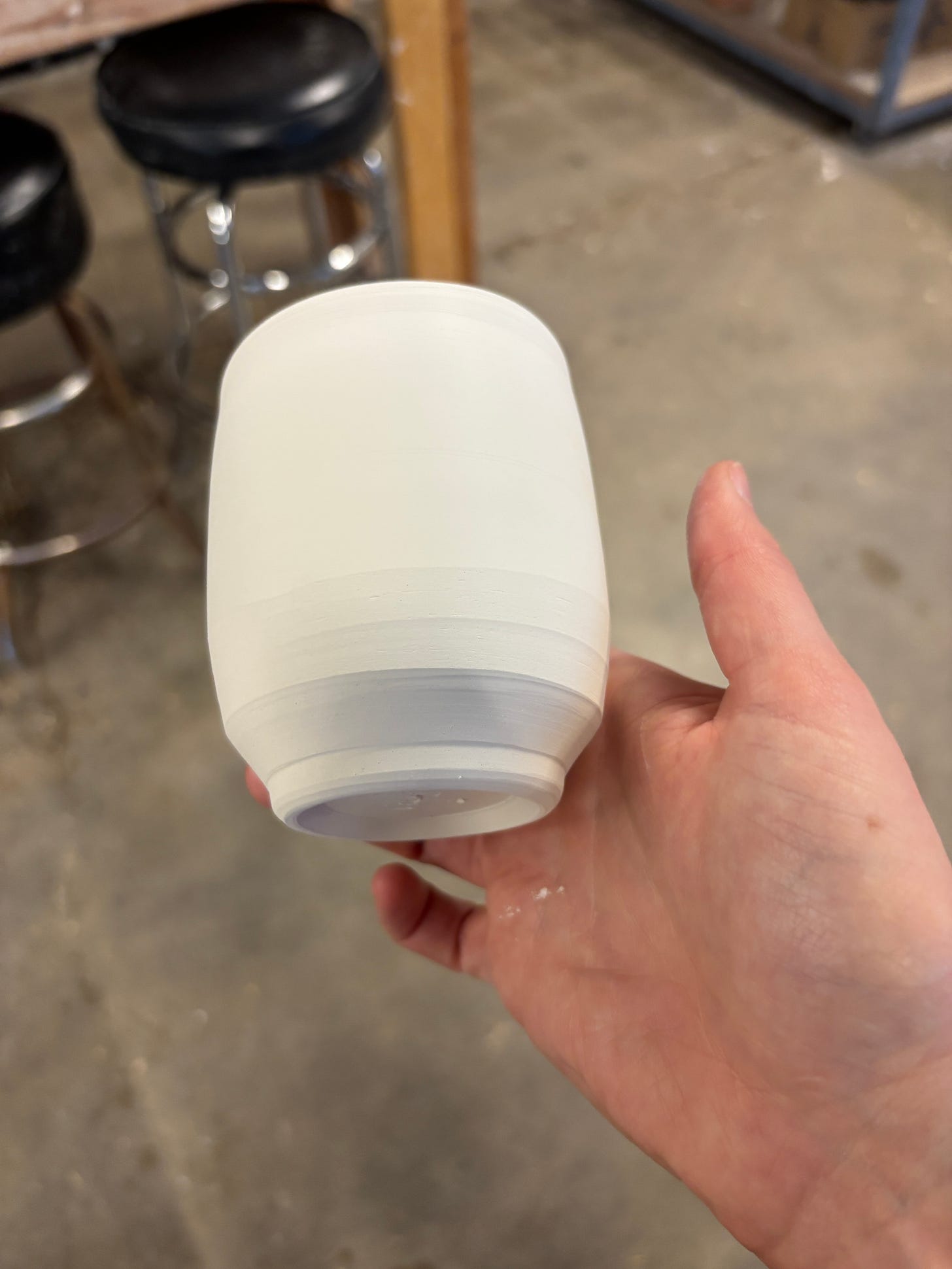 trimmed cup in hand with bottom of cup showing