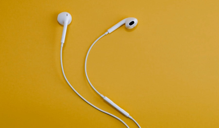 Apple EarPods on yellow surface