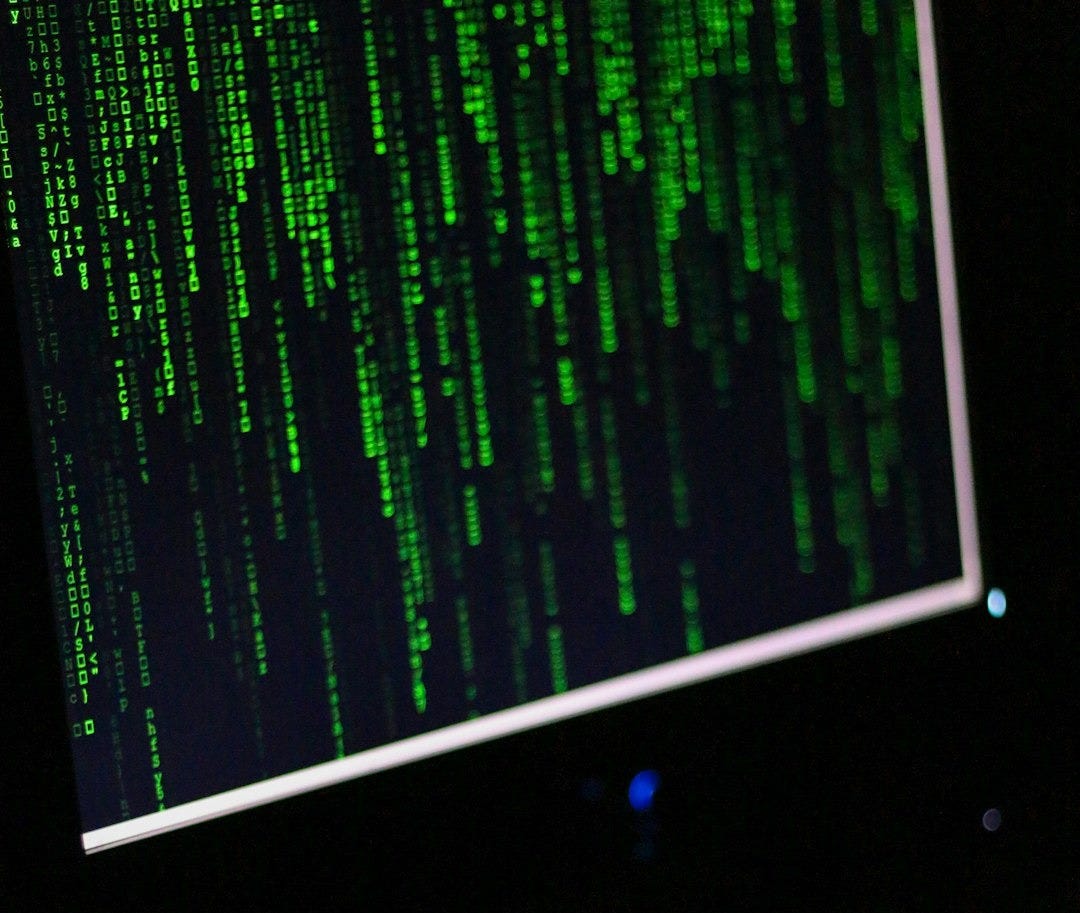 A computer monitor sitting on top of a desk