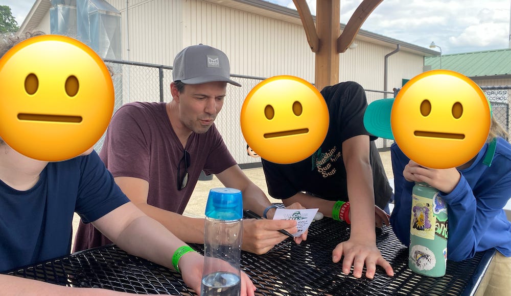 A picture of me and my kids at a minigolf course.