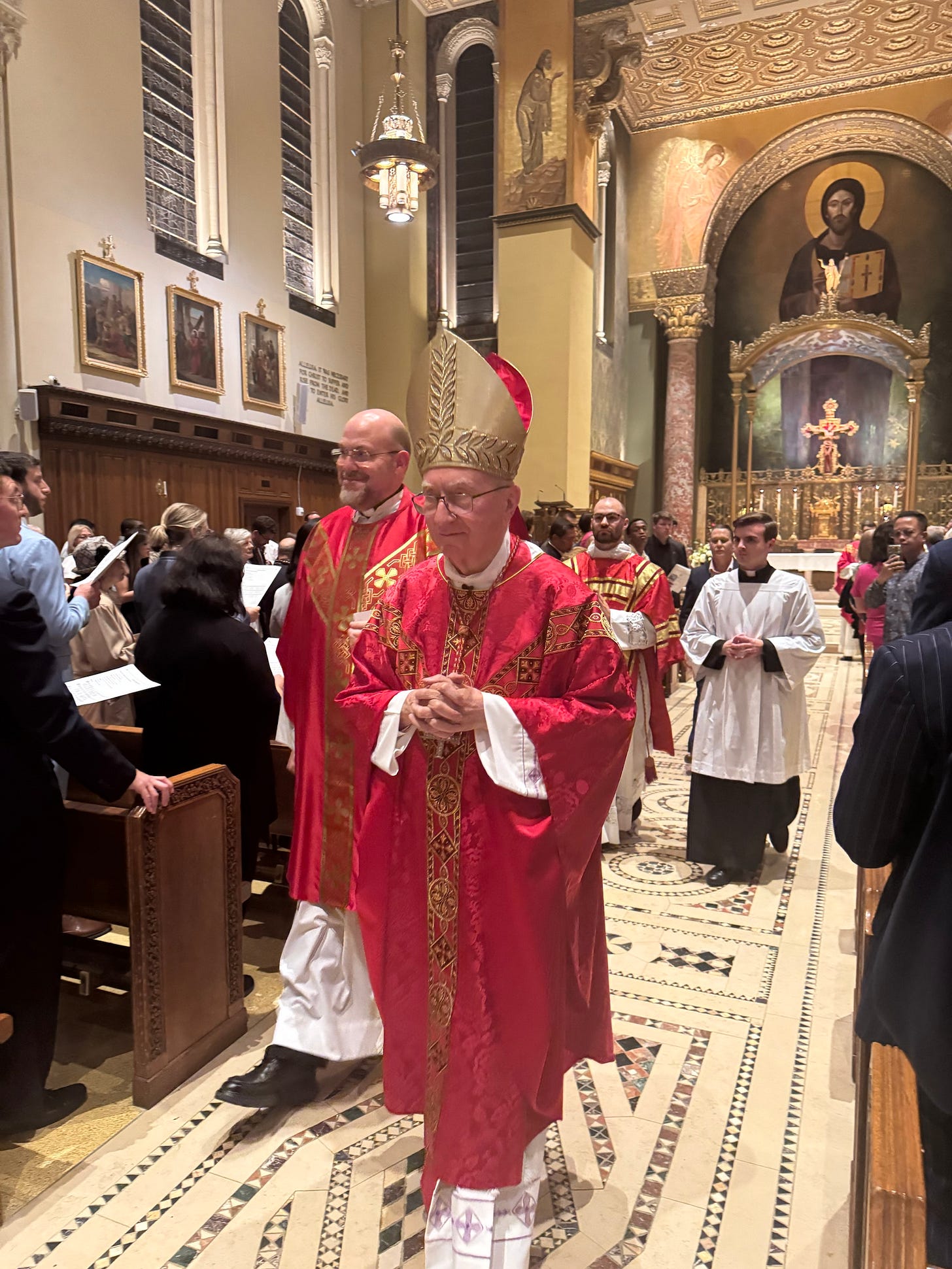 Cardinal Parolin processes out of the Church of Our Saviour in red vestments and mitre Cardinal Parolin processes out of the Church of Our Saviour in red vestments and mitre