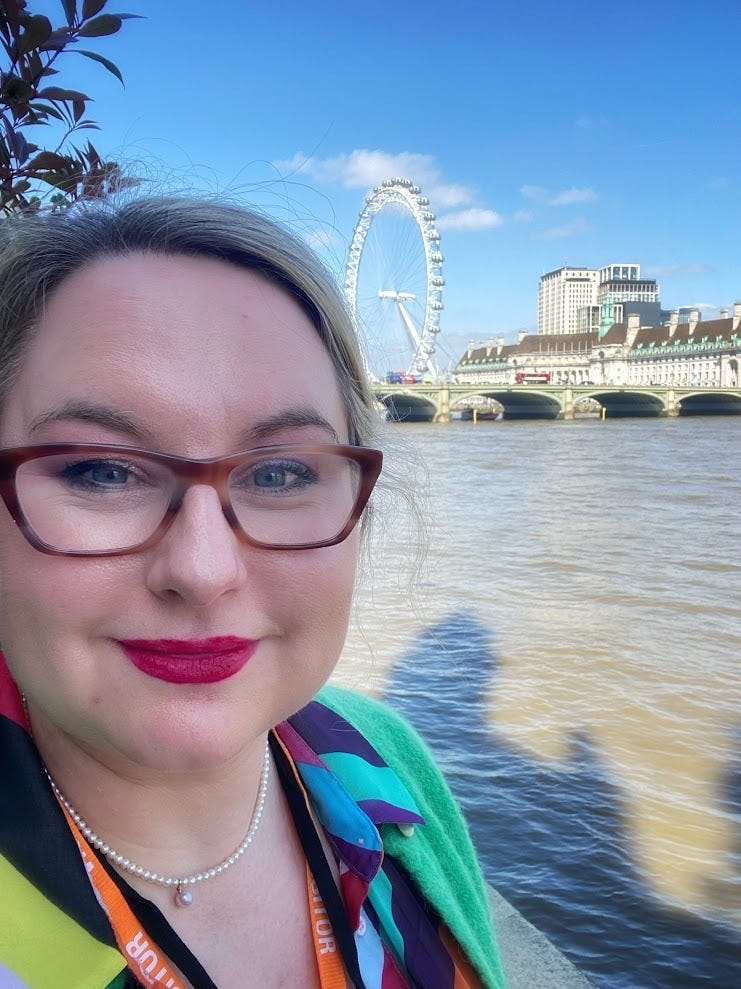 A selfie of me in front of the River Thames. In the background there is the London Eye. 