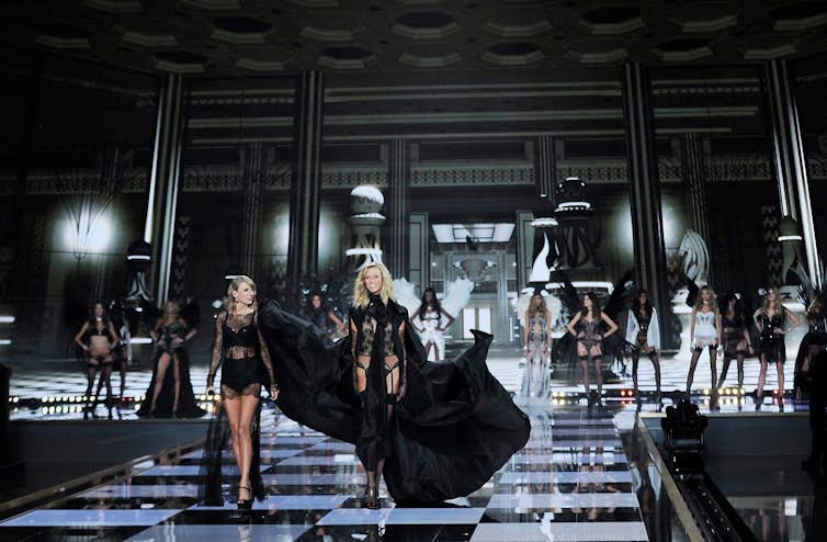 A cat walk, both dressed in black
