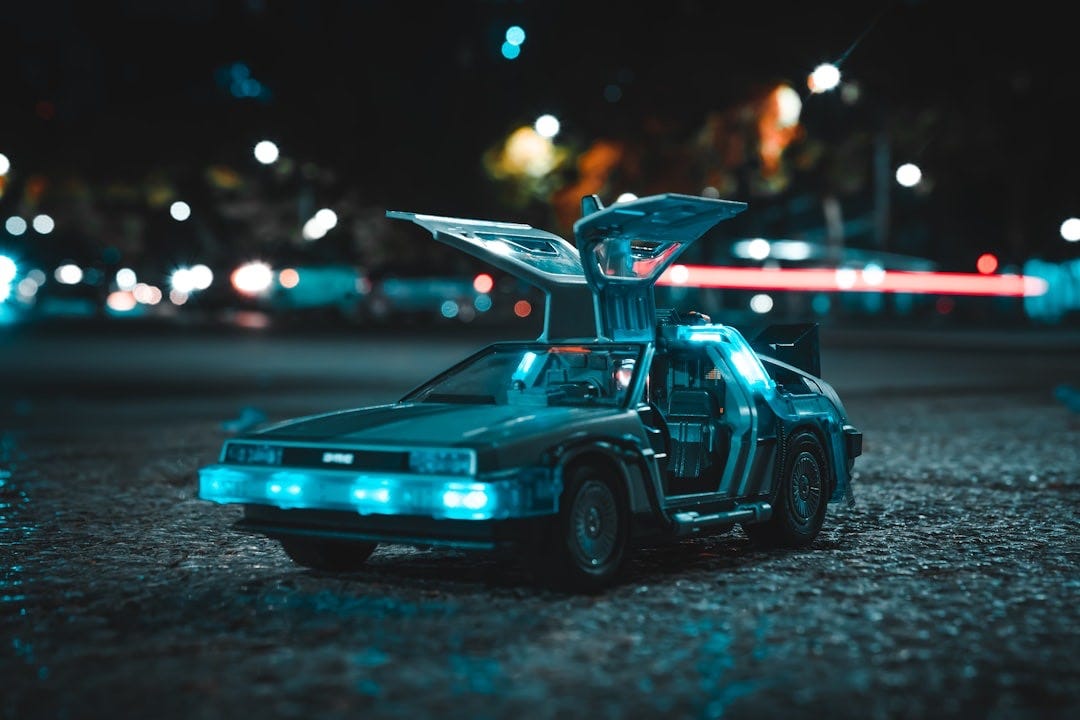 a toy car with its hood open sitting on the ground a toy car with its hood open sitting on the ground