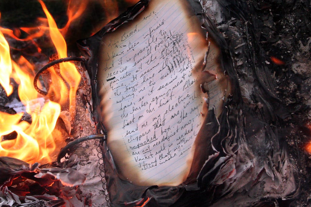 A spiral bound notebook burning in a fire