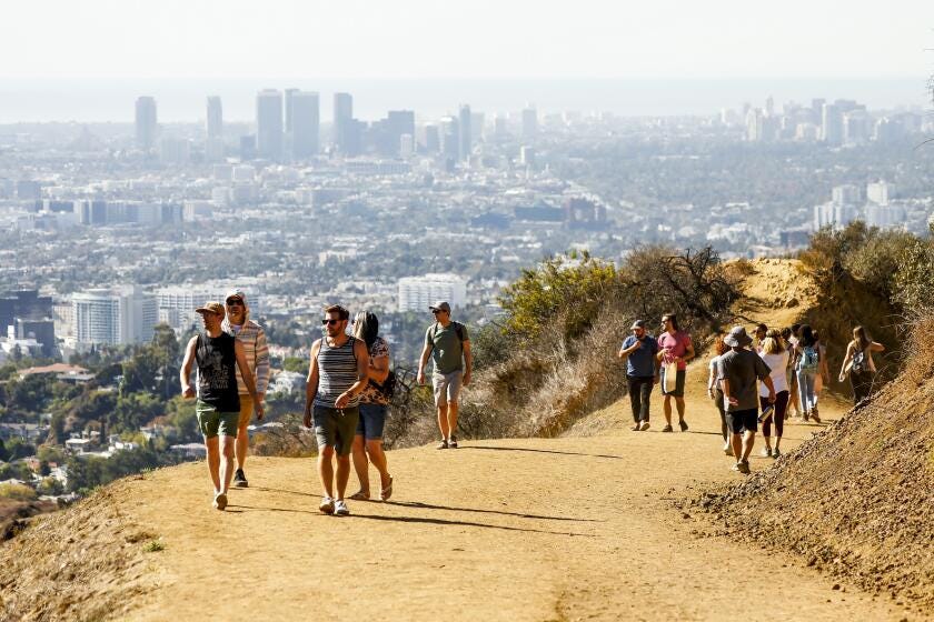 LOS ANGELES, CA - NOVEMBER 11: Hikers enjoy views to the Pacific Ocean on the Mt Hollywood Trail leading to the peak of Mount Hollywood at 1,625 ft which is the second tallest peak in Griffith Park. The trails provide amazing views of the Griffith Observatory, downtown Los Angeles, the Hollywood Sign and views to the Pacific Ocean on clear days. much more. There are many trails that lead to Mt. Hollywood, but a favorite trail begins near the Ferndell Nature Area. Griffith Park on Thursday, Nov. 11, 2021 in Los Angeles, CA. (Al Seib / Los Angeles Times).