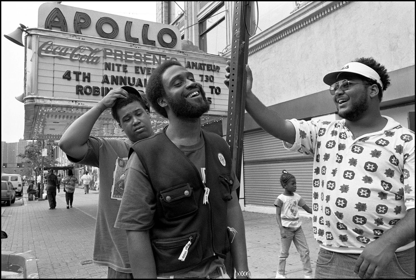 A group of men standing on the street

Description automatically generated