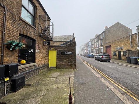 From a quiet street in Deal to the narrow hallway and intimate rooms beyond, the Walk Don't Walk Gallery invites visitors to step inside, be nosey, and discover an art space where humour, conversation and curiosity shape the experience as much as the works on the walls. — © Kent Chronicles