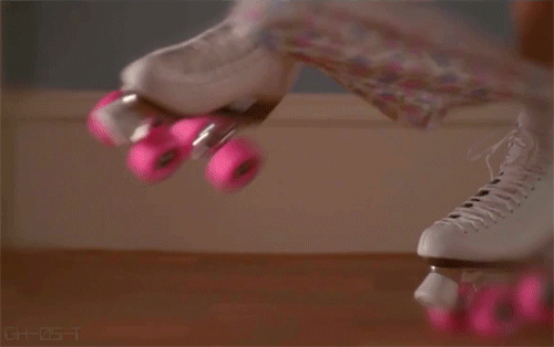 This may contain: a pair of pink roller skates are shown in this image, with one person's feet touching the ground This may contain: a pair of pink roller skates are shown in this image, with one person's feet touching the ground