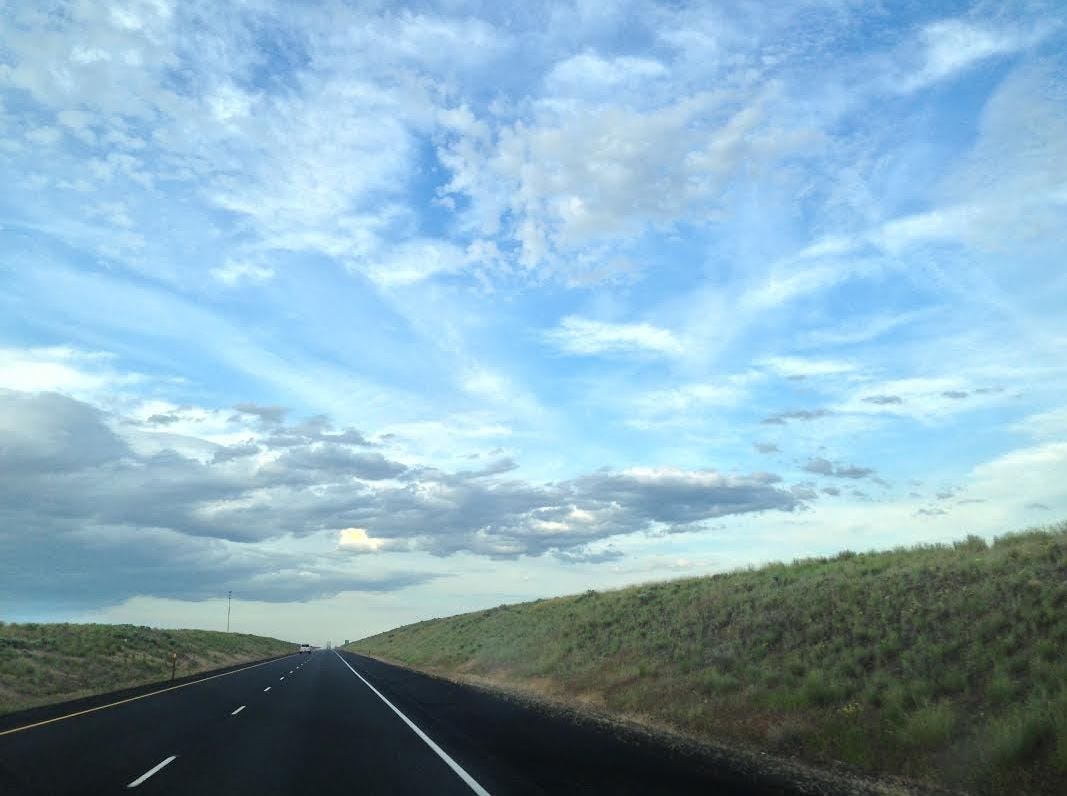 clouds lonely stretch of road