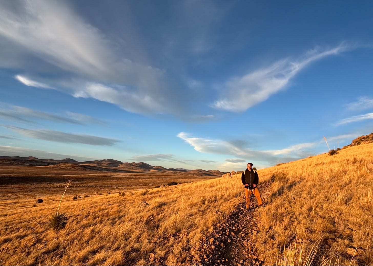 man on hiking trail in desert landscape
