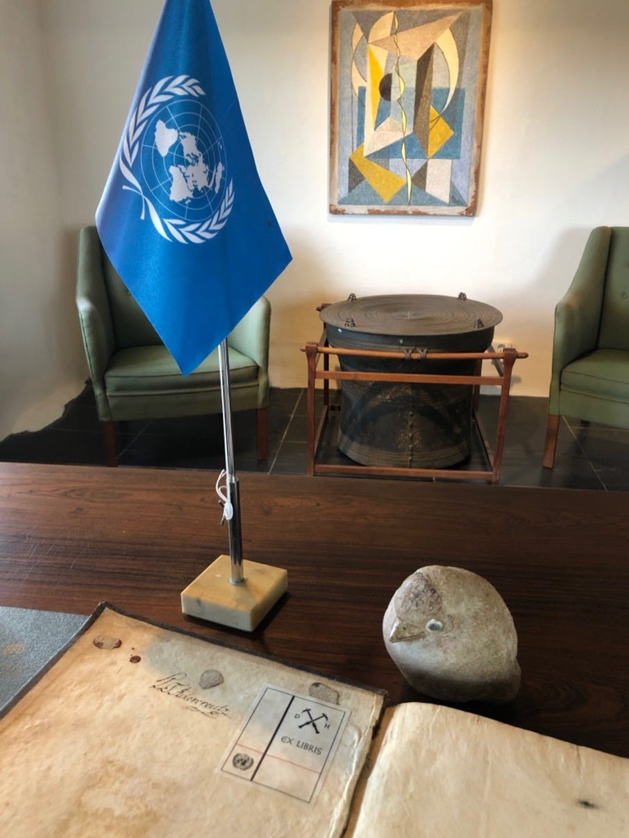 View over a desk towards a wall with objects