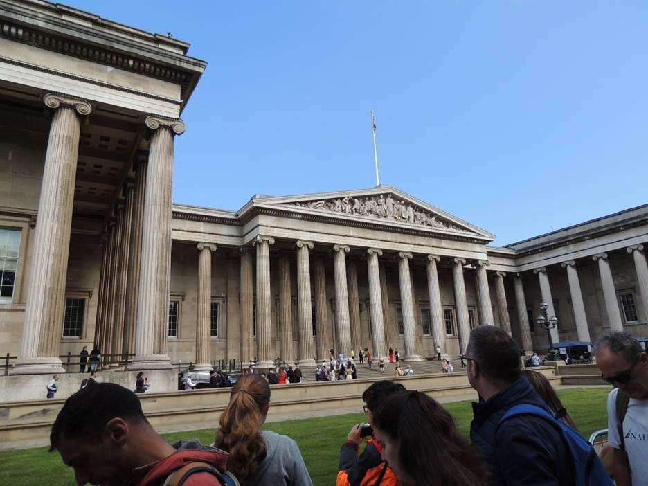 A group of people standing outside of a building

AI-generated content may be incorrect.
