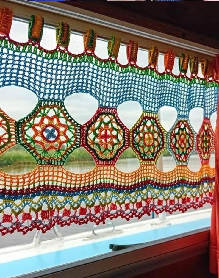 This may contain: the window is decorated with colorful crochet and beads on it's side