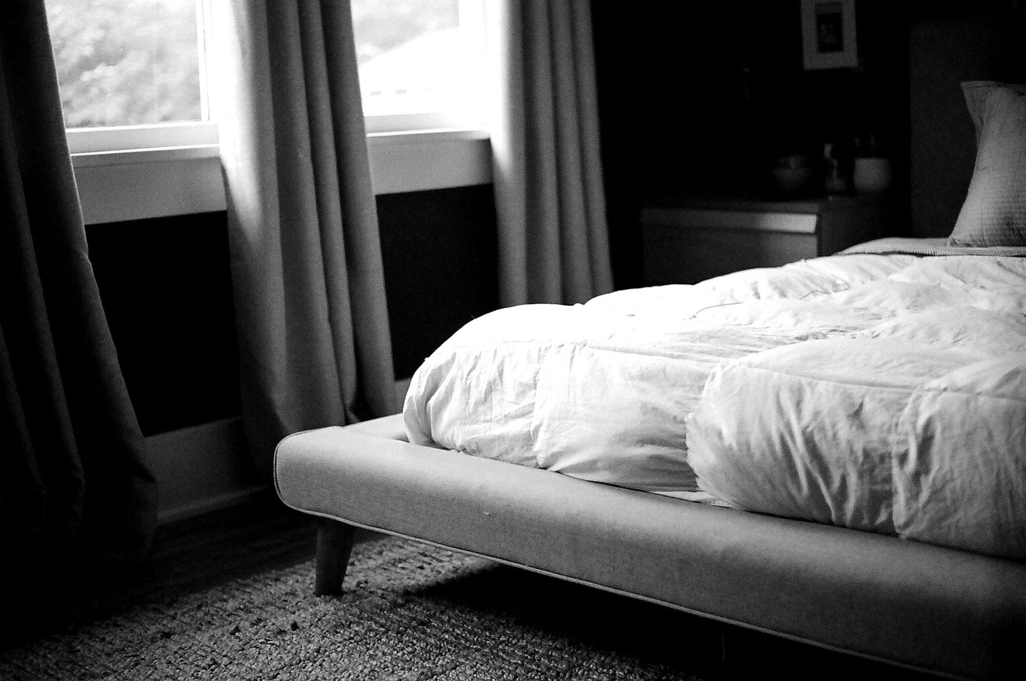 white bed by the window during daytime white bed by the window during daytime