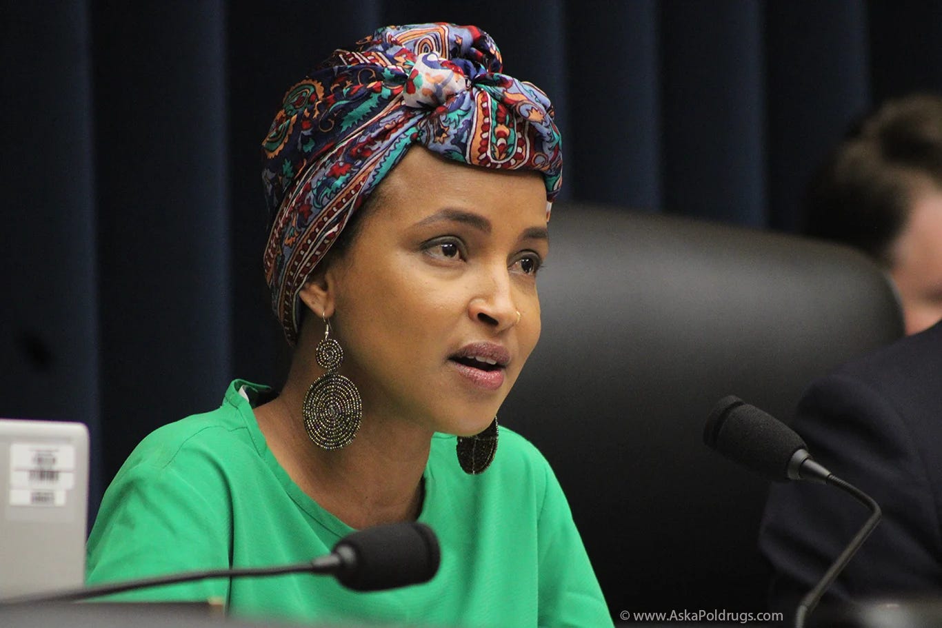 A Black Muslim US congresswoman questions a witness at a hearing at the US Capitol. Photo: Logan Johnson © www.askapoldrugs.com 