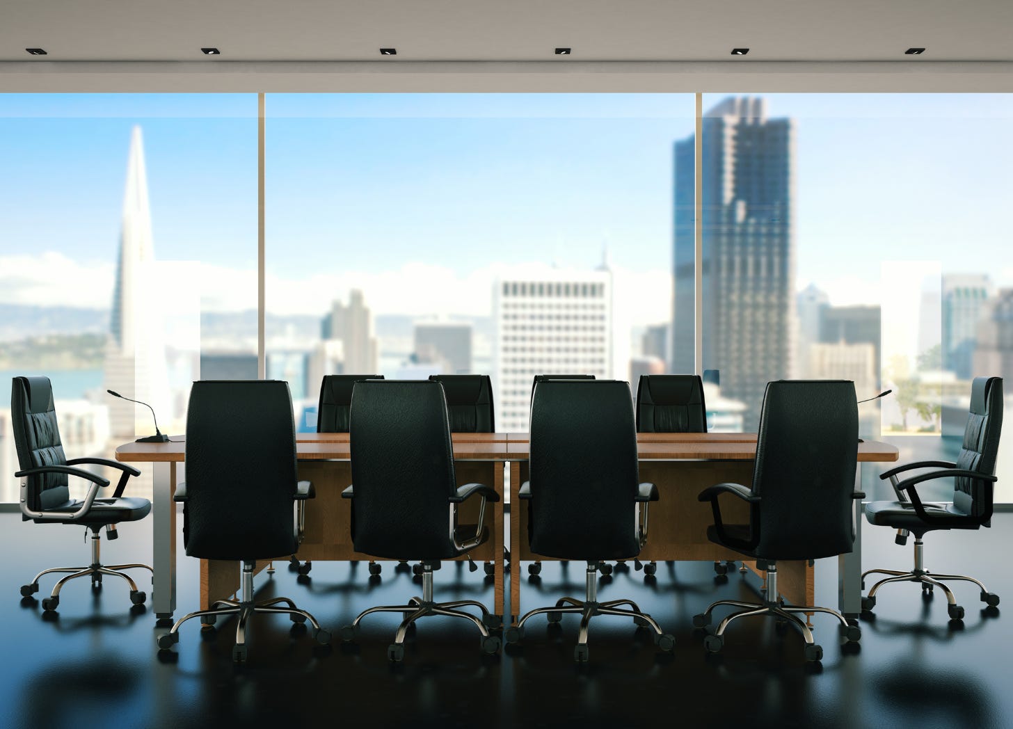 Boardroom with a high-rise city view behind it