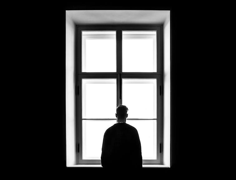 man standing in front of the window