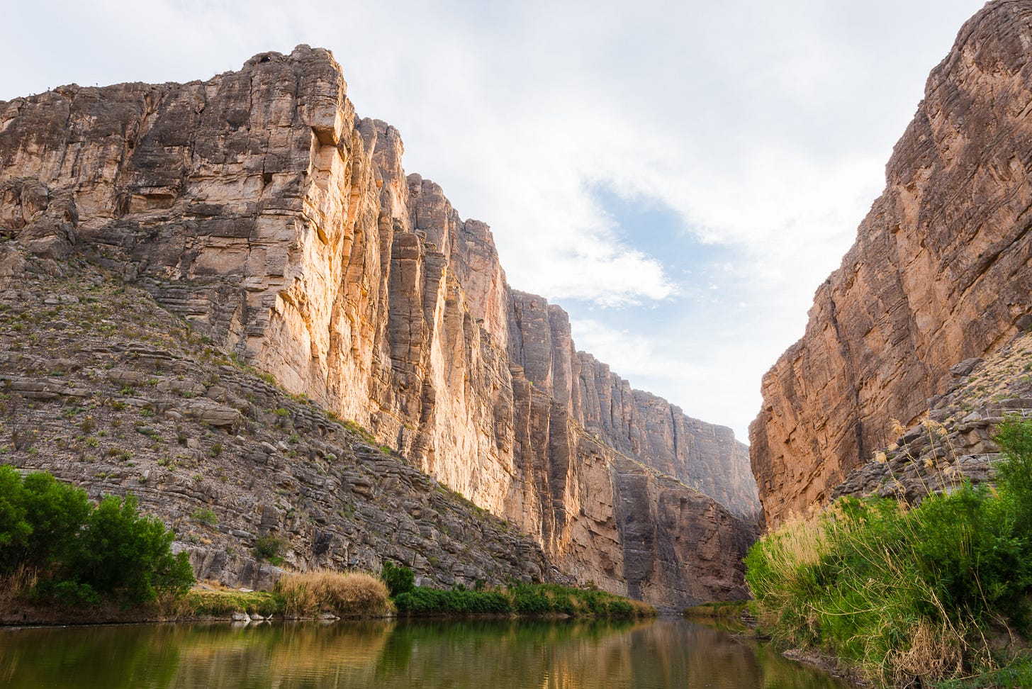Water beneath two tall canyon walls.