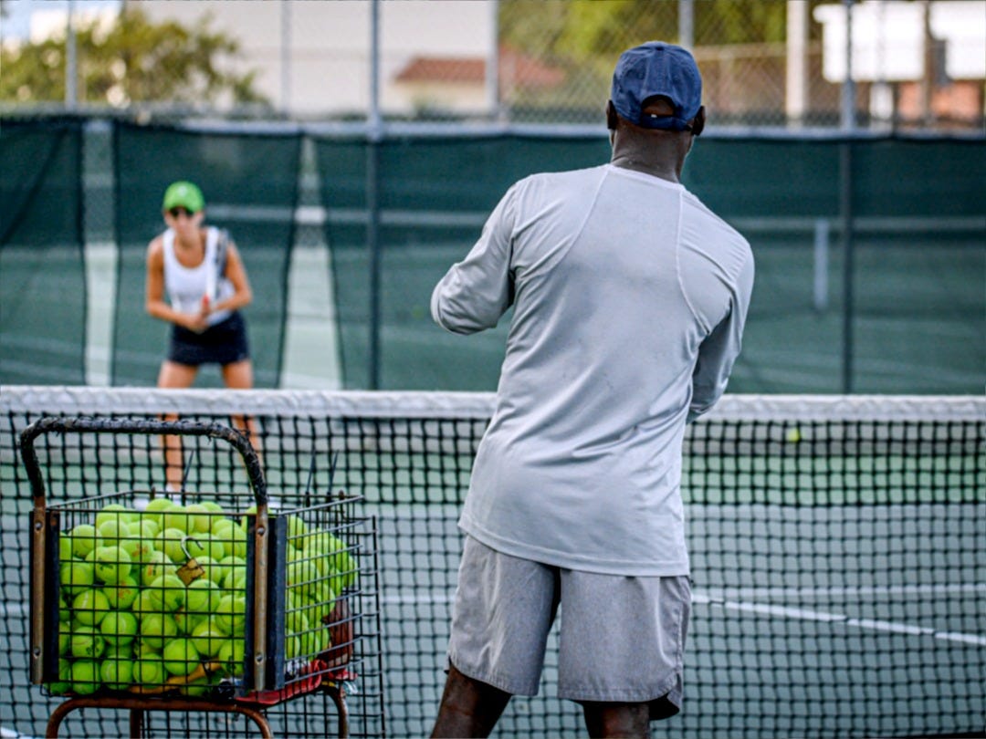 a man and a woman playing tennis on a tennis court
