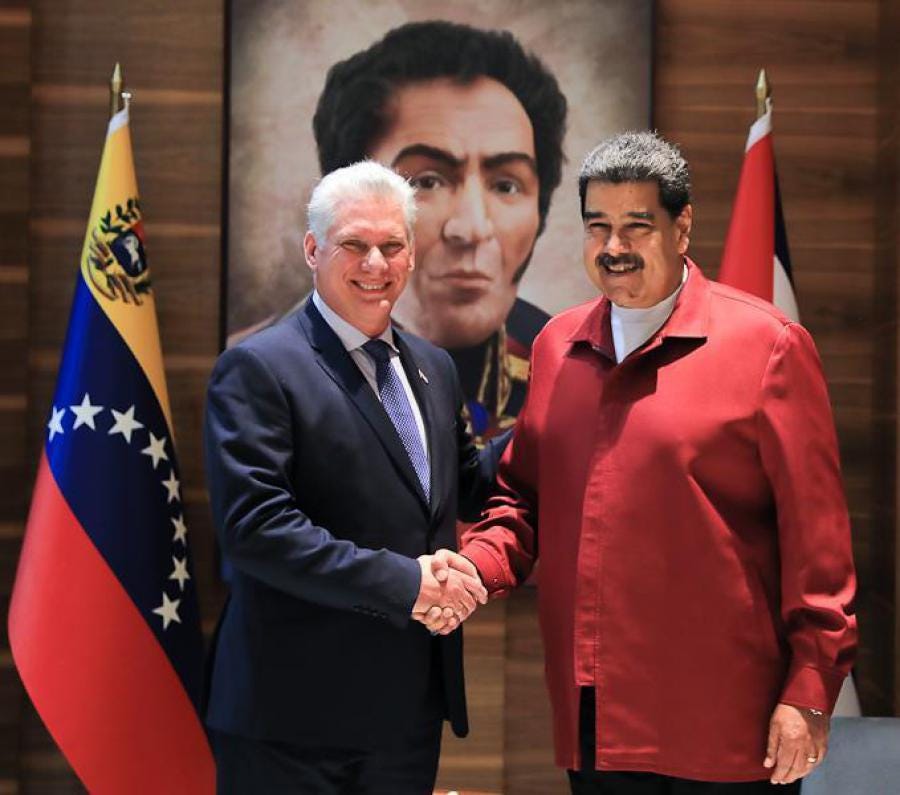 Two men shaking hands in front of flags

AI-generated content may be incorrect.
